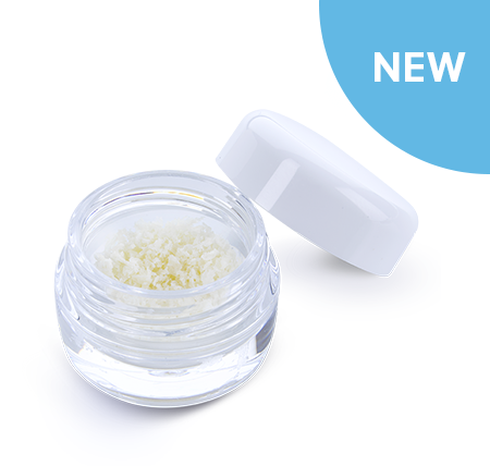 A professional, angled shot of the new ZimVie RegenerOss® Allograft Particulate, a demineralized bone matrix material for dental procedures. The image shows the fine particulate in a clear, open jar with its white cap resting beside it. This product is a versatile and reliable solution for a variety of dental bone grafting applications, including extraction site preservation and ridge augmentation, providing an osteoconductive scaffold for successful bone integration.