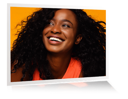 A confident, joyful woman with a bright, natural smile—highlighting the aesthetic results of ZimVie Encode® Emergence Healing Abutments designed for optimal tissue healing and beautiful restorative outcomes.